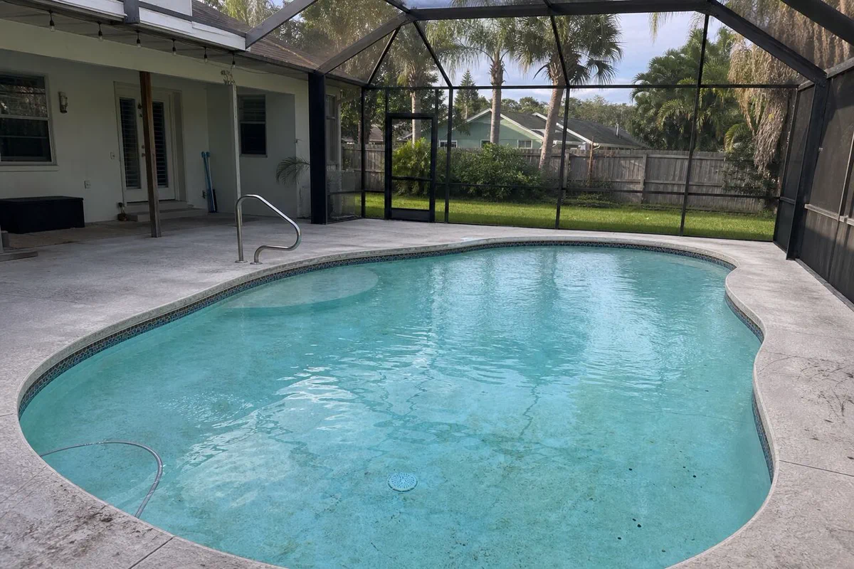 Finished white plaster (marcite) pool surface under clear water